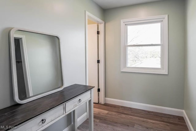 mudroom with baseboards and dark wood-type flooring