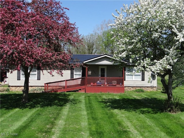 22742 US Route 30, Minerva, OH 44657 - view of front of home with a garage, a wooden deck, and a front lawn