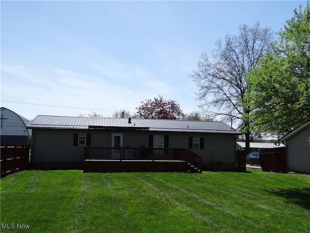 22742 US Route 30, Minerva, OH 44657 - back of property featuring a lawn, a standing seam roof, a wooden deck, and metal roof