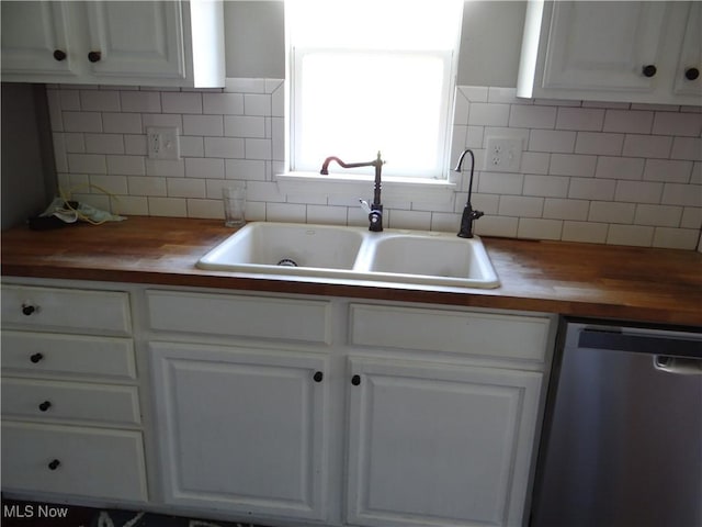 22742 US Route 30, Minerva, OH 44657 - kitchen featuring a sink, decorative backsplash, stainless steel dishwasher, and butcher block counters