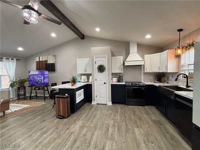 53206 Poplar Dr, Bridgeport, OH 43912 - kitchen with black / electric stove, custom exhaust hood, a sink, plenty of natural light, and recessed lighting