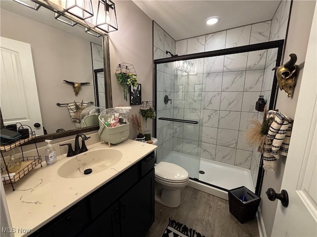 53206 Poplar Dr, Bridgeport, OH 43912 - full bath with wood finished floors, a shower stall, toilet, vanity, and recessed lighting