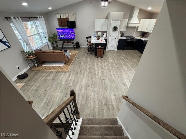 53206 Poplar Dr, Bridgeport, OH 43912 - living area featuring light wood finished floors, vaulted ceiling, baseboards, a ceiling fan, and recessed lighting