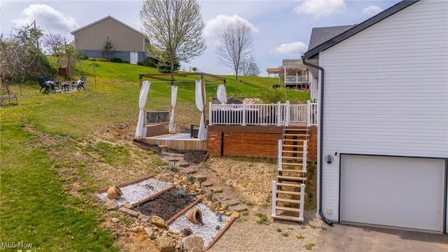 53206 Poplar Dr, Bridgeport, OH 43912 - view of grassy yard featuring an attached garage, stairway, and a wooden deck