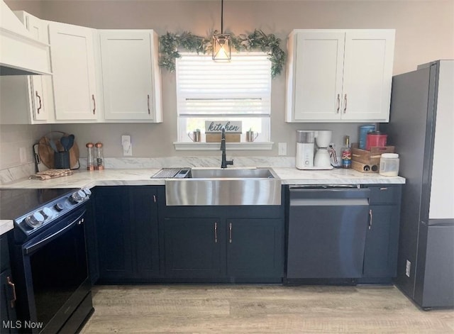 53206 Poplar Dr, Bridgeport, OH 43912 - kitchen with dishwasher, a sink, black range with electric stovetop, freestanding refrigerator, and custom exhaust hood