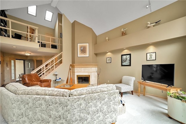 4845 Timber Creek Dr, Medina, OH 44256 - carpeted living room featuring high vaulted ceiling, baseboards, and a tile fireplace