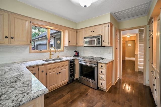 kitchen with visible vents, wine cooler, light stone counters, a sink, and appliances with stainless steel finishes