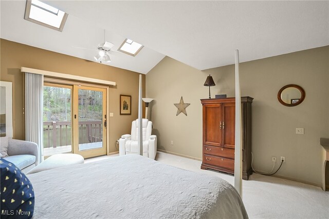 bedroom with light carpet, access to exterior, a ceiling fan, baseboards, and lofted ceiling with skylight