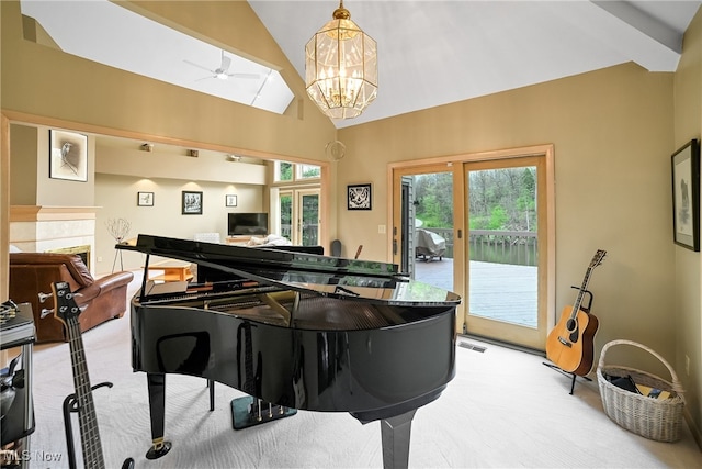 interior space with high vaulted ceiling, visible vents, and ceiling fan with notable chandelier