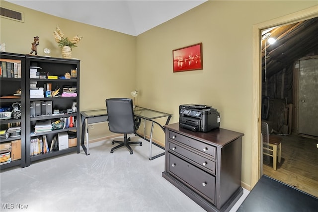office space with baseboards, visible vents, lofted ceiling, and carpet