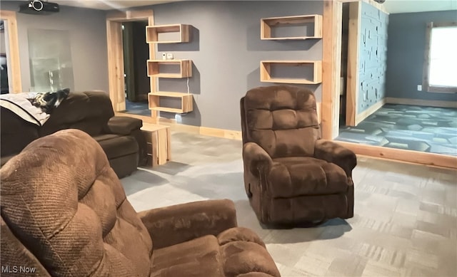 carpeted living room with baseboards