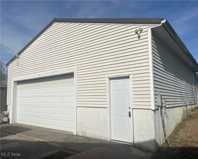 exterior space with a garage and an outdoor structure