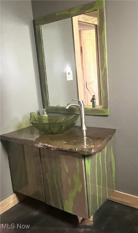 bathroom featuring baseboards and vanity