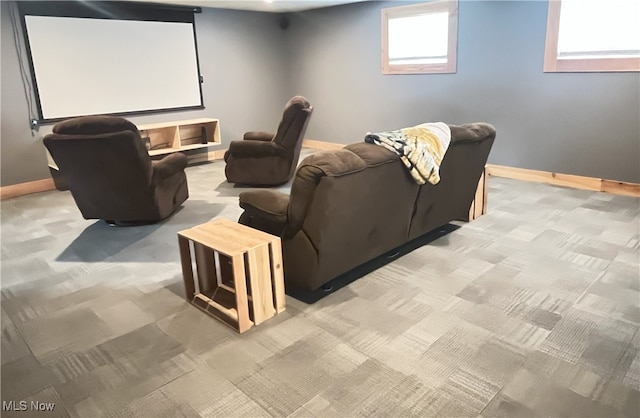 carpeted cinema room with baseboards