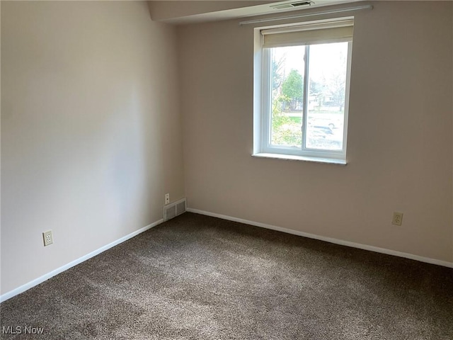 unfurnished room with visible vents, carpet flooring, and baseboards