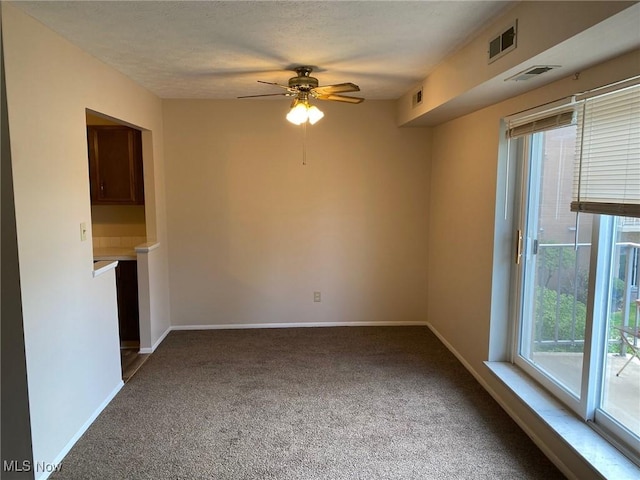 unfurnished living room with carpet floors, visible vents, and plenty of natural light