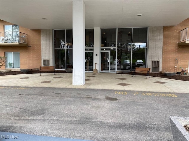 property entrance featuring brick siding