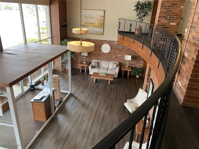 interior space with wood finished floors and brick wall