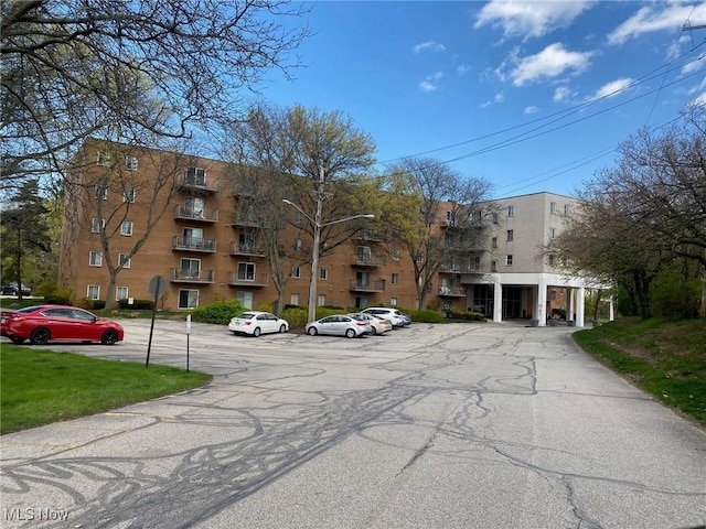 view of building exterior with uncovered parking