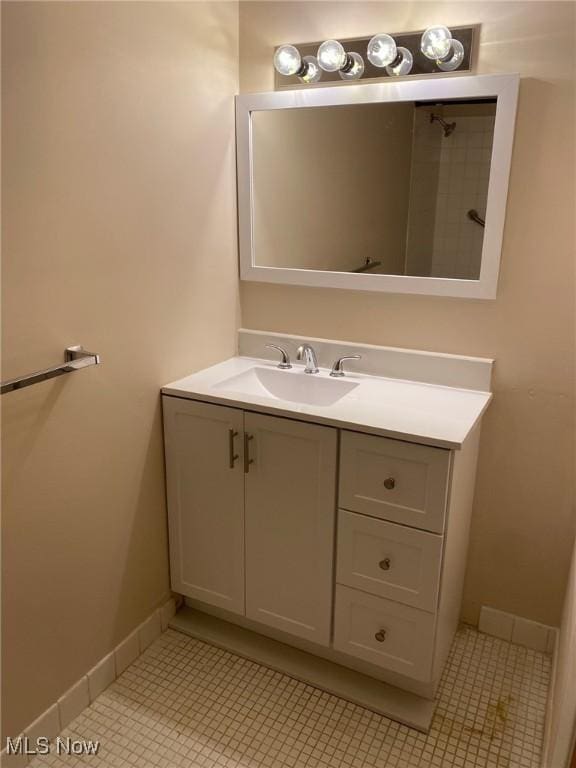 bathroom with baseboards, vanity, and tile patterned floors