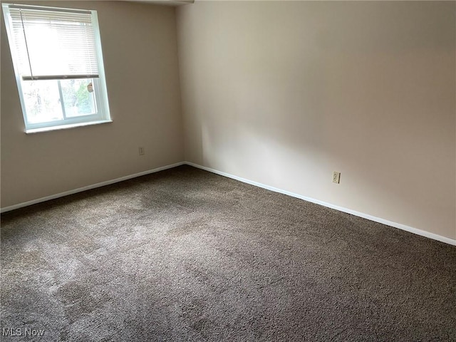 empty room with carpet and baseboards
