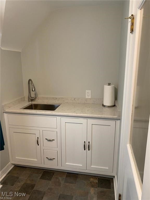 3016 Croydon Dr NW, Canton, OH 44718 - bar featuring a sink, stone finish floor, and vaulted ceiling