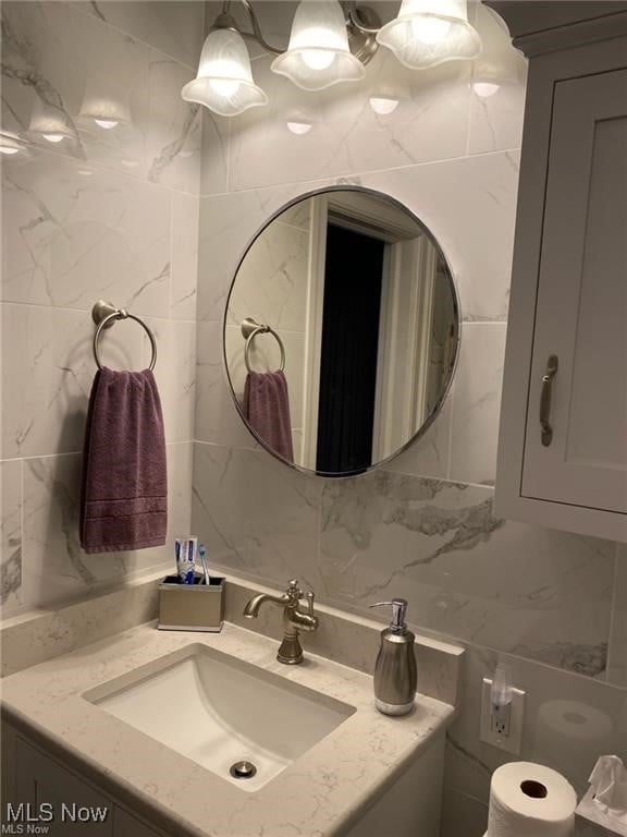 3016 Croydon Dr NW, Canton, OH 44718 - bathroom featuring tile walls, vanity, and tasteful backsplash