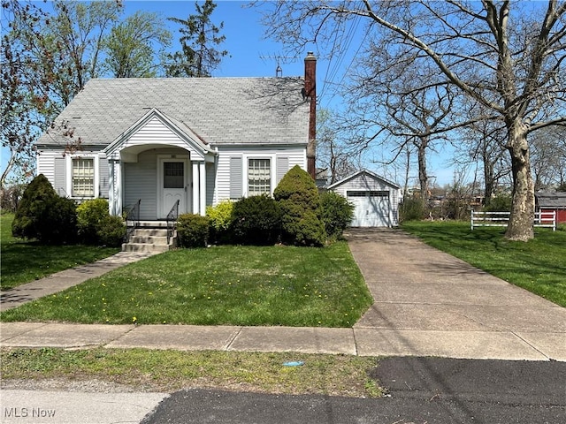 201 Gilcher Ct, Sandusky, OH 44870 - bungalow-style home featuring a garage, a front yard, driveway, and an outbuilding