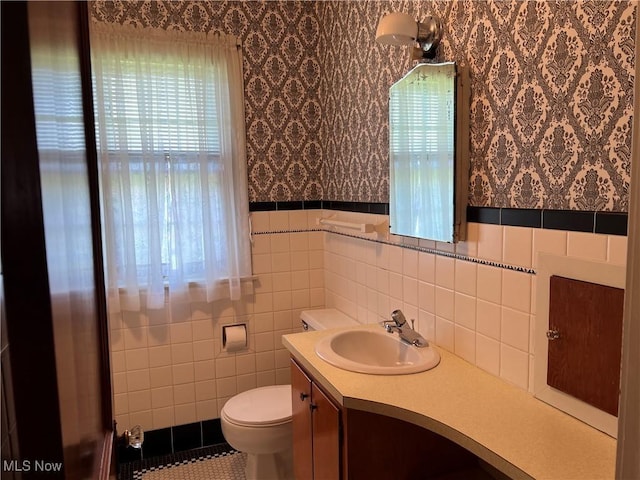 201 Gilcher Ct, Sandusky, OH 44870 - bathroom with wallpapered walls, toilet, vanity, and wainscoting