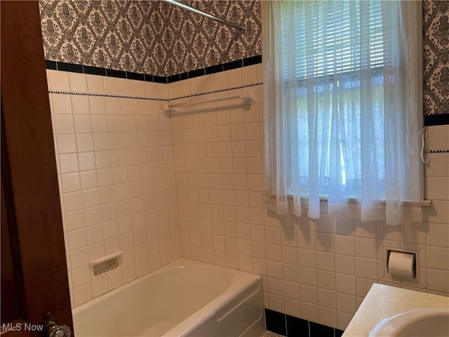 201 Gilcher Ct, Sandusky, OH 44870 - bathroom featuring wallpapered walls, tile walls, and shower / tub combination