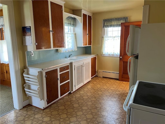 201 Gilcher Ct, Sandusky, OH 44870 - kitchen with baseboard heating, a sink, white appliances, light floors, and light countertops