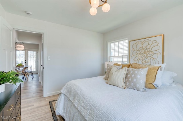 bedroom with light wood-style flooring and baseboards