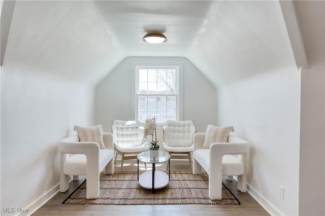 sitting room with vaulted ceiling, wood finished floors, and baseboards