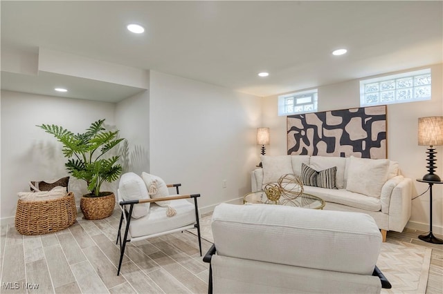living area featuring baseboards, recessed lighting, and light wood-style floors