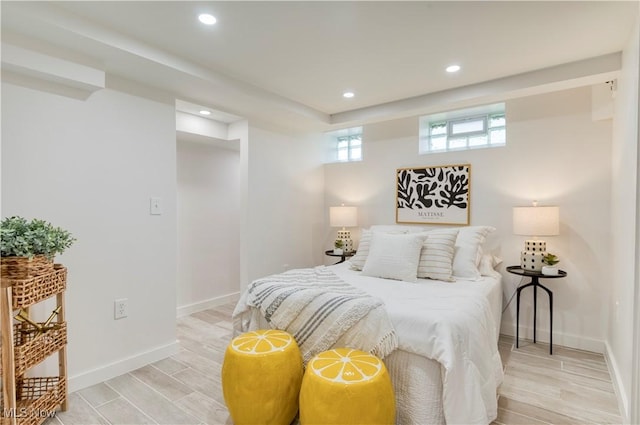 bedroom featuring light wood finished floors, baseboards, and recessed lighting