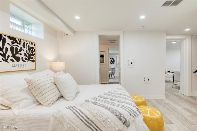 bedroom featuring wood finished floors, visible vents, and recessed lighting