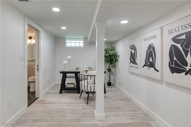 interior space featuring baseboards, recessed lighting, and light wood-type flooring