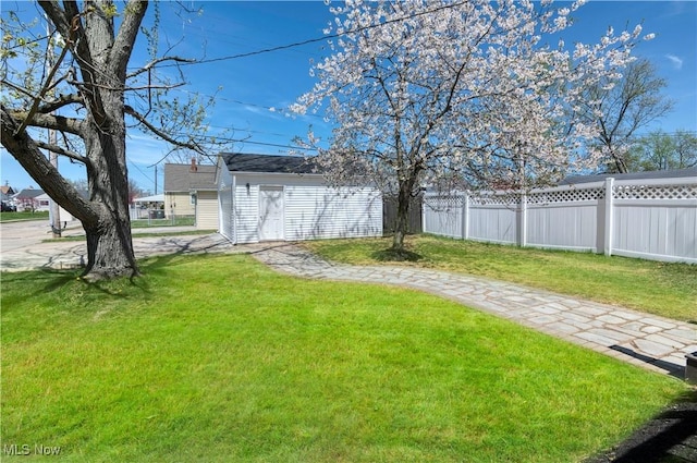 view of yard featuring fence and an outdoor structure
