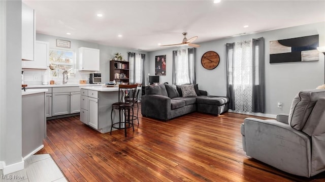living area with recessed lighting, dark wood finished floors, and a ceiling fan