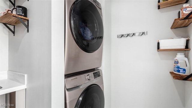 laundry area with stacked washer / dryer and laundry area