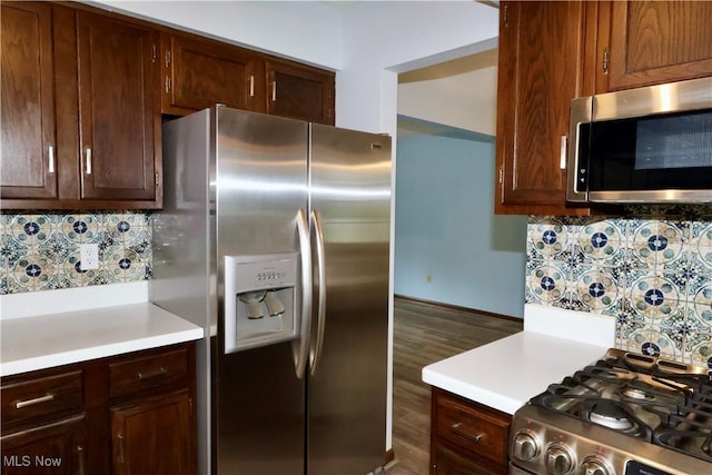 4479 Azalea Ln, North Olmsted, OH 44070 - kitchen with wood finished floors, stainless steel appliances, light countertops, backsplash, and baseboards