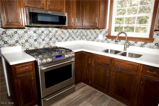 4479 Azalea Ln, North Olmsted, OH 44070 - kitchen with light countertops, backsplash, stainless steel appliances, and a sink