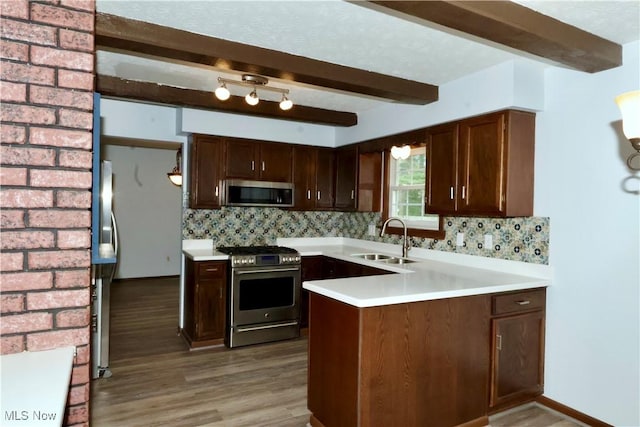 4479 Azalea Ln, North Olmsted, OH 44070 - kitchen with light wood finished floors, a sink, tasteful backsplash, beamed ceiling, and appliances with stainless steel finishes