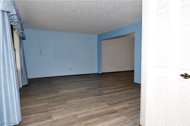 4479 Azalea Ln, North Olmsted, OH 44070 - spare room featuring baseboards, wood finished floors, and a textured ceiling