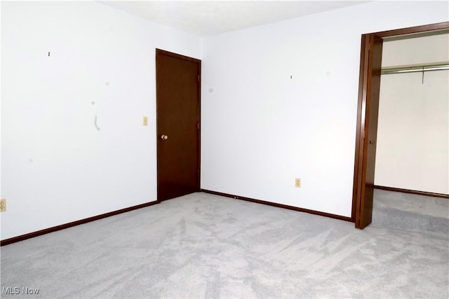 4479 Azalea Ln, North Olmsted, OH 44070 - unfurnished bedroom with baseboards, a closet, and light colored carpet