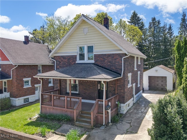 view of front of property with brick siding, a garage, a chimney, an outdoor structure, and driveway