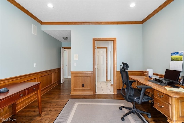office space with wood finished floors, crown molding, and a wainscoted wall