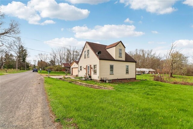 944 Bey Rd, Akron, OH 44312 - view of side of home with a lawn and a garage