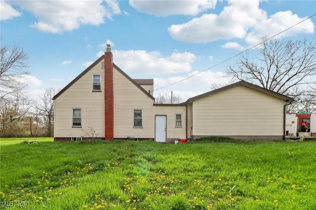 944 Bey Rd, Akron, OH 44312 - back of house with a chimney and a yard