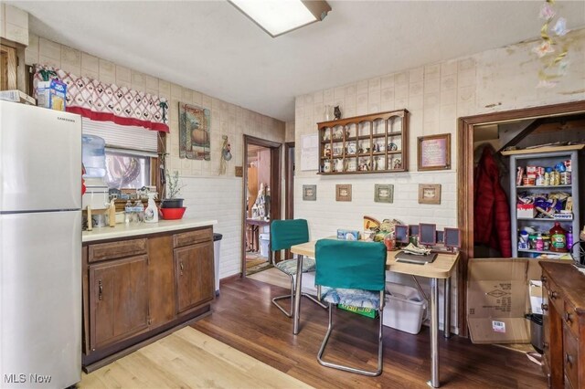 944 Bey Rd, Akron, OH 44312 - kitchen with freestanding refrigerator, wood finished floors, light countertops, and glass insert cabinets
